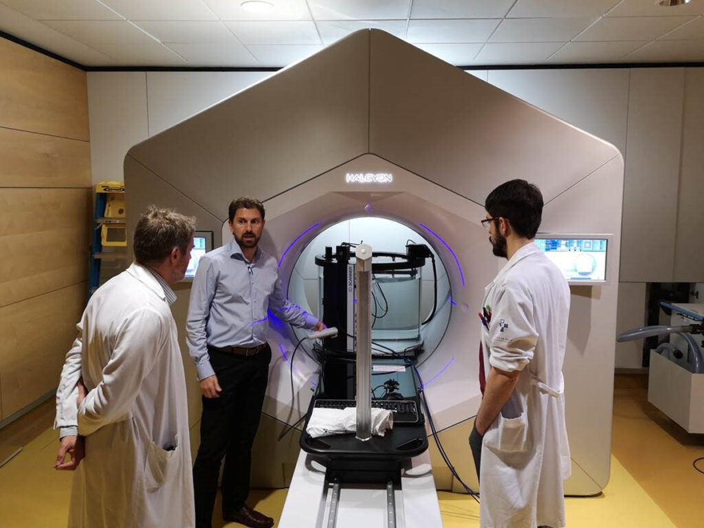 Picture of three people looking at, and using the 3D SCANNER in a hospital in Asturias, Spain