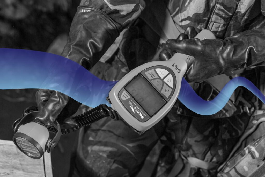 Black & White picture of the Tracerco Contamination Monitor T401, with a blue swirl edited through the picture